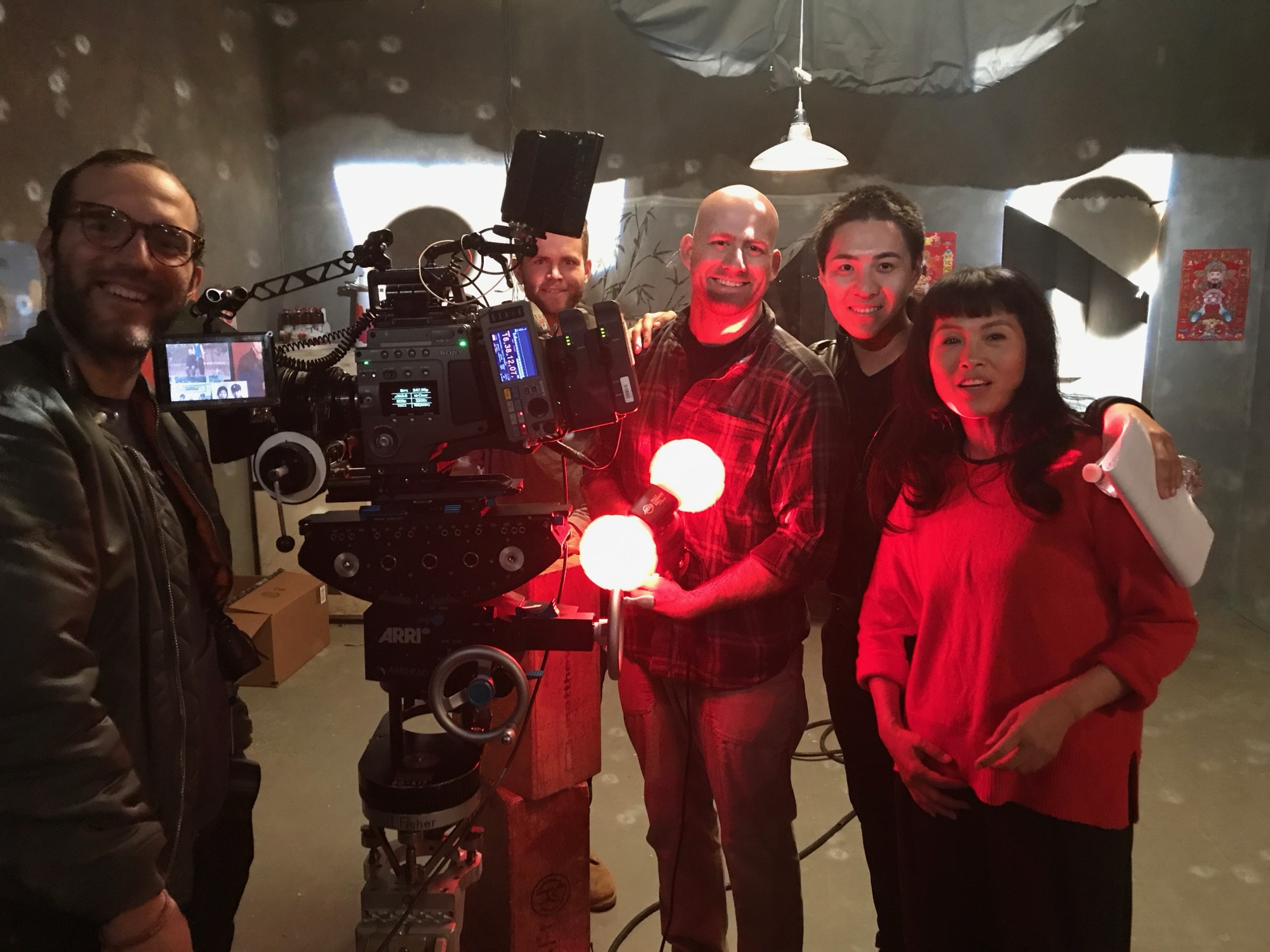 Grace Chang with her film crew beside an ARRI cinema camera on set