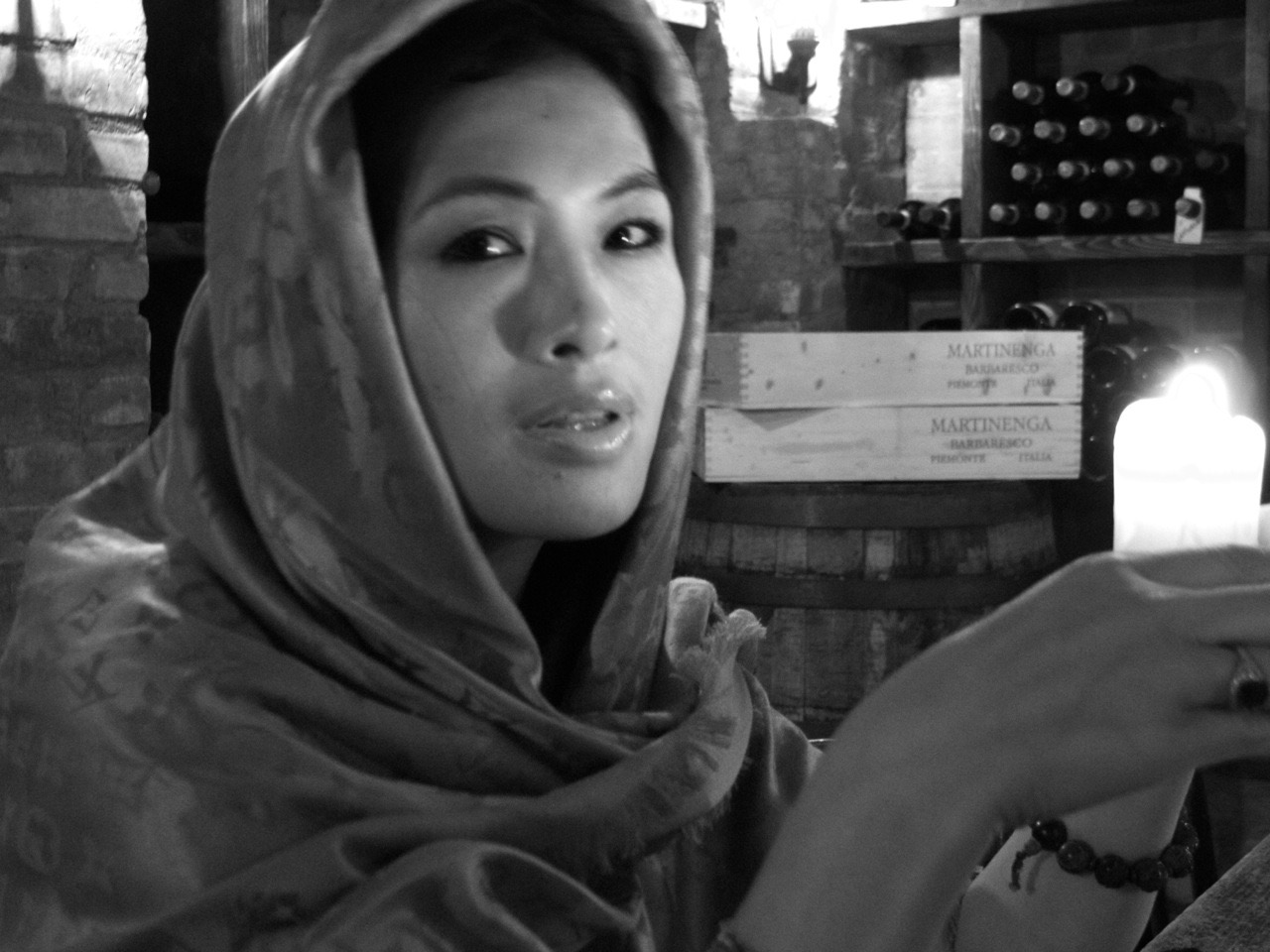 Black and white portrait of Grace Chang wearing a silk scarf by candlelight